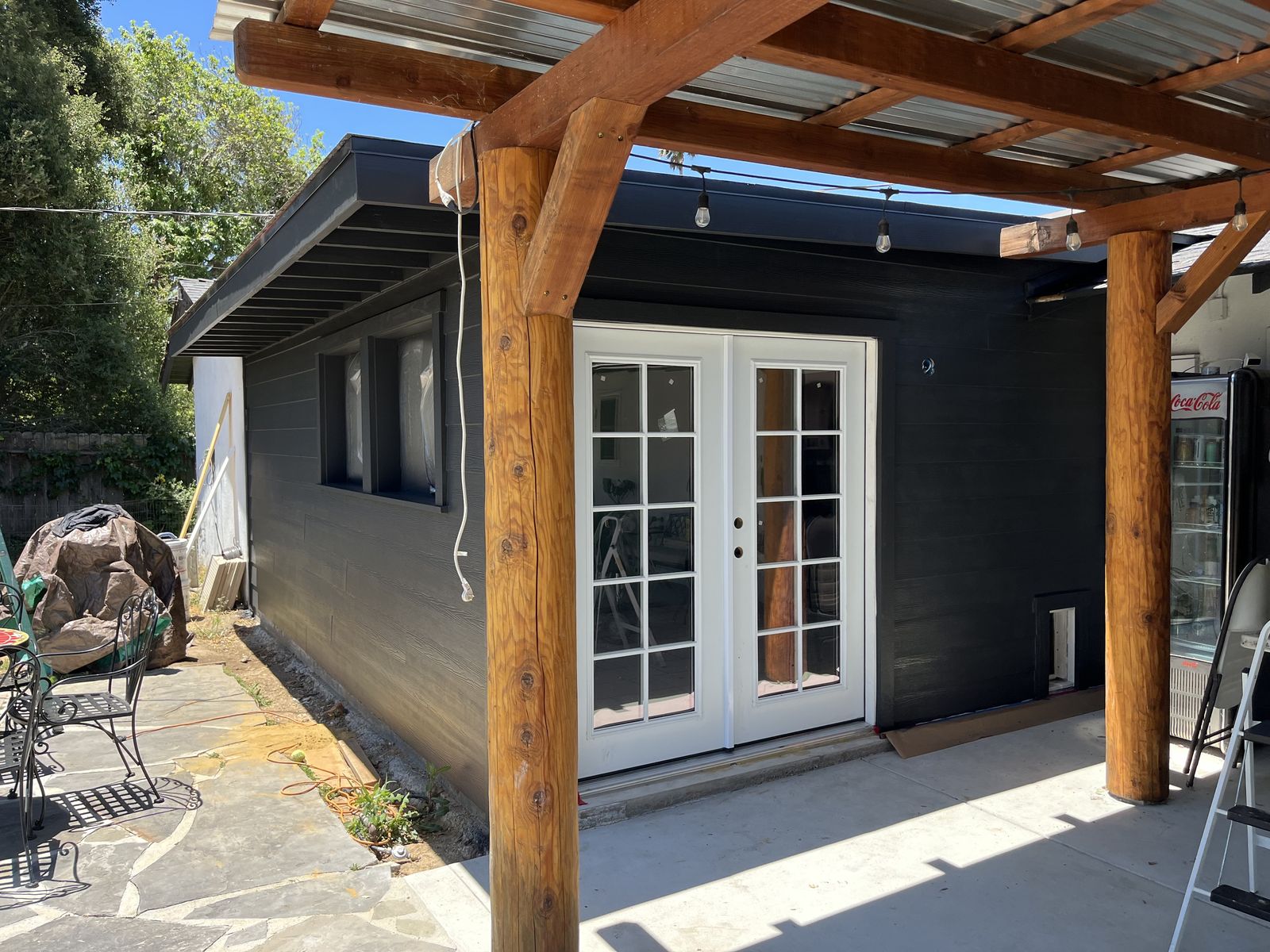Dark charcoal ADU exterior with wood pergola and French doors in Buellton, CA